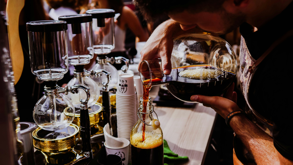 Part time Barista pouring coffee in a jug